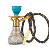 Hookah with blue bowl, gold and clear base, and black hose on a white background